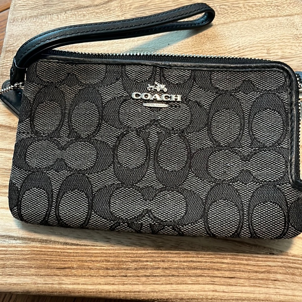 Black Coach wristlet.  Shows normal gentle wear.